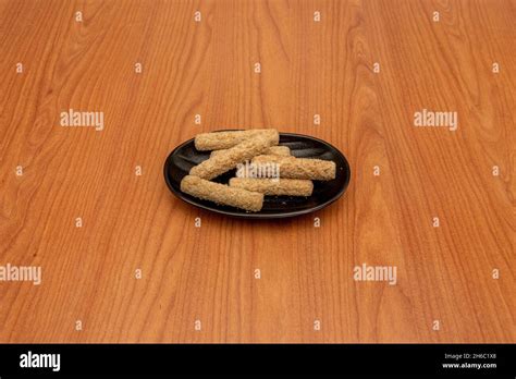 Battered Mozzarella Sticks On Black Plate Stock Photo Alamy