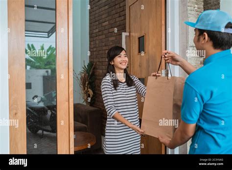 Delivery Man Delivering Food To A Man At Home Online Food Shopping